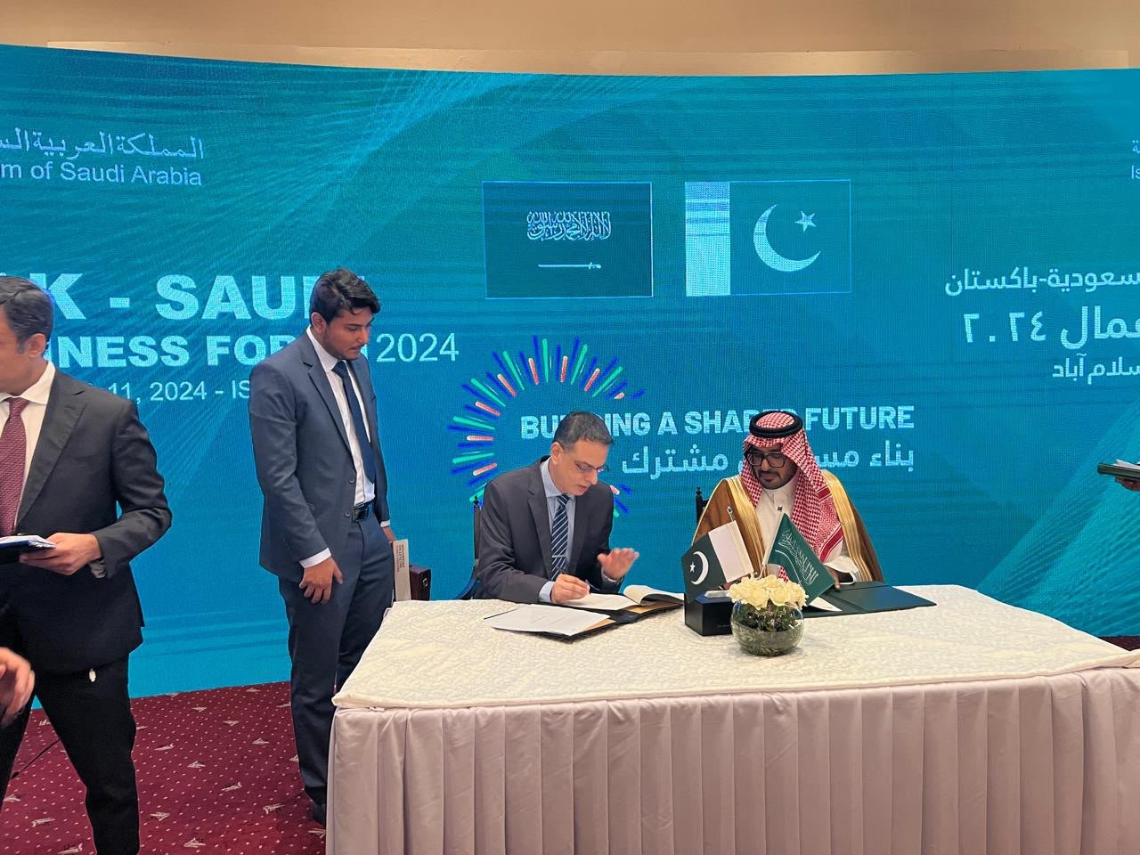 Officials signing memorandum of understanding at the forum